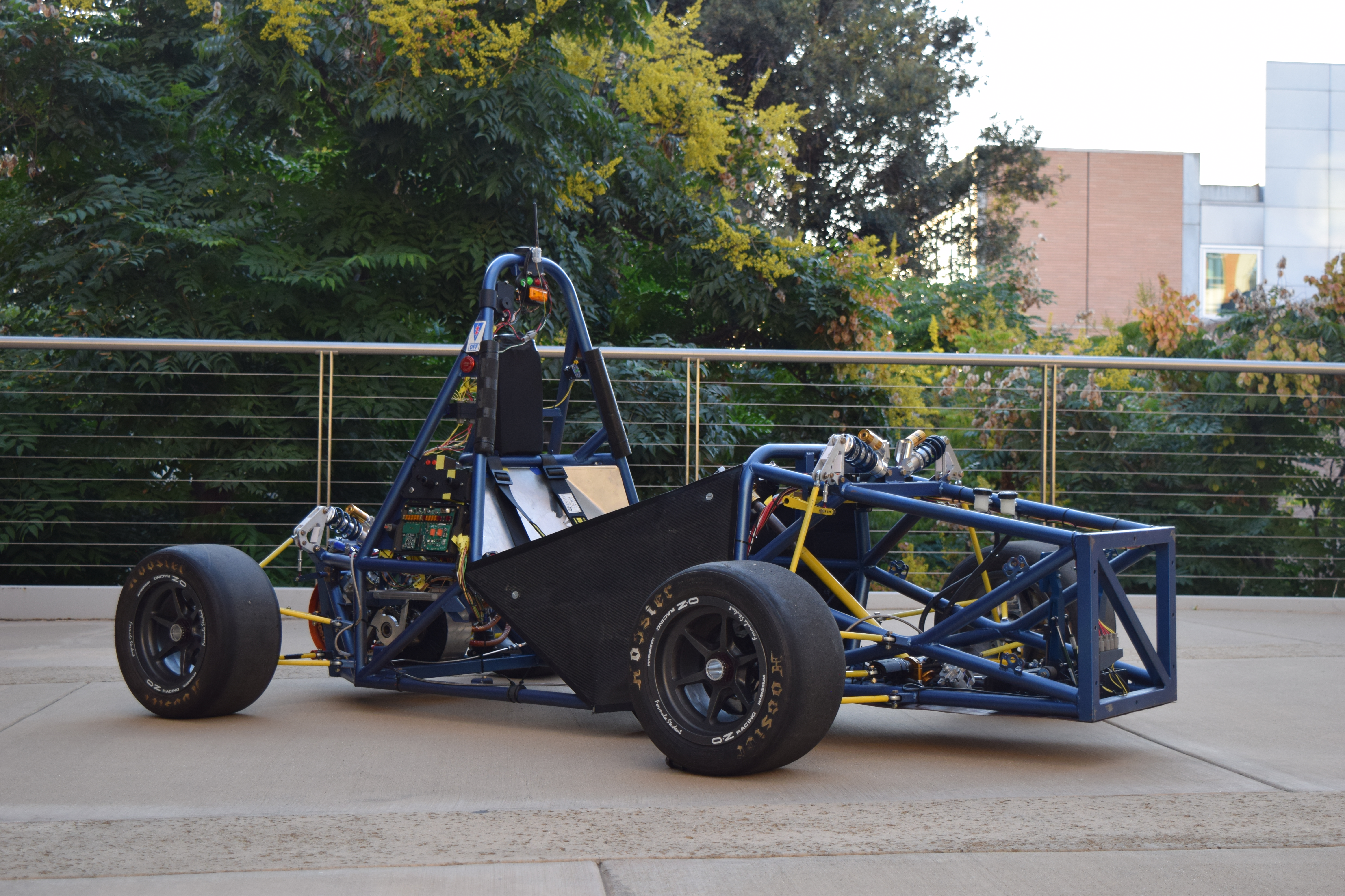 Highlander Racing electric car with an exposed blue chassis on campus in September 2026